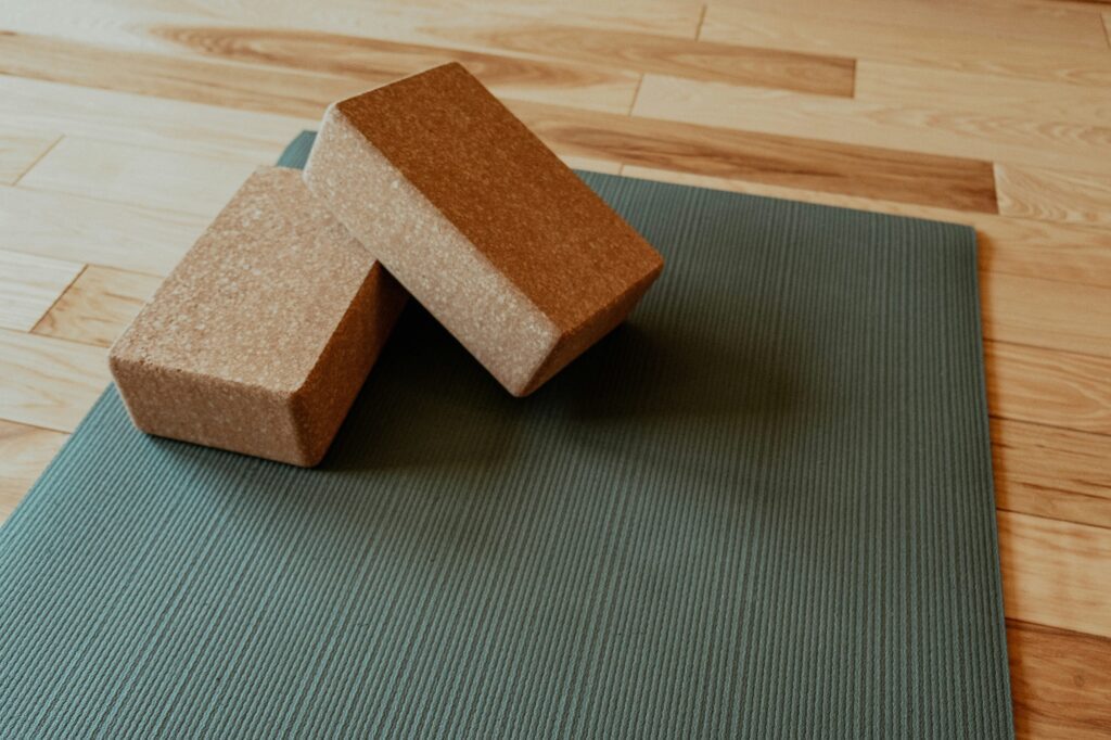 Yoga mat and yoga blocks inviting you to engage with Real Reasons To Start Practicing!